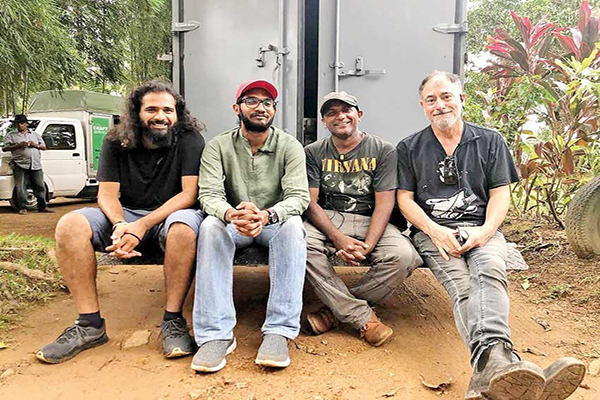 Ihshan with Deepa Mehta and Assistant Art Director Gayan Madushan It is a beautiful film and I want everyone to watch and learn our history We have a lot of amazing actors here but their experience in film is minimal Local directors need to stop casting their favourites and explore for new talent I don’t see why people have to make a fuss about a film made by Canada, promoting filming in Sri Lanka Deepa Mehta’s ‘Funny Boy’, a Canadian drama film shot in Sri Lanka, is to be released on Netflix today. Based on acclaimed writer Shyam Selvadurai’s book of the same title, the coming-of-age film follows a young Tamil boy who explores his sexuality. His personal struggles however are depicted against the backdrop of the tensions building between Tamils and Sinhalese, on the cusp of the brutal three-decade civil war. Ihshan and Shyam on the sets of Funny Boy the film was named as Canada’s international feature film entry for the 2021 Oscars Sri Lanka’s film industry had great but untapped potential, especially in terms of actors ‘Funny Boy’ deals with several controversial subjects. The book and the film offer rare insights to our island nation’s violent history as well as homosexuality. Unsurprisingly, it has attracted many criticisms even before it’s release since the film was named as Canada’s international feature film entry for the 2021 Oscars. Much has been said about the film, the cast, the criticisms and the challenges. Daily Mirror Insight spoke to young Sri Lankan filmmaker Ihshan Iqbal about what it was like behind the scenes of Funny Boy. Second Assistant Director (AD) Vamsi Krishna Ihshan, Third AD Prasad Pereira & First AD Reid Dunlop A career in film is not a natural choice in Sri Lanka, especially for those with no family ties or other connections to the industry. What was it that drove Ihshan towards the film, we asked. “All this started when I volunteered for the Colombo Film Festival in 2015. It wasn’t random but I would say it was the universe giving me a chance. I met a few like-minded people with whom I still collaborate, my Editor Trilan Shastri, and my Cinematographer Sandaruwan Abeysinghe. My first commercial job was a TV commercial for a milk brand called ARLA. I got a call from Pearly Hanan, who wanted me to come and meet the Line Producer Lylie Almeida. They gave me my first job. Being hired as a Set Production Assistant, was something amazing where I got to learn about each department and what they were involved in,” Ihshan recalled. Funny Boy isn’t Ihshan’s maiden involvement in international film. He has also worked on all three seasons of British TV series the ‘Good Karma Hospital’ and ‘Greed’ by Micheal Winterbottom. For five years, Ihshan has been slowly and steadily laying the foundation for success, working as an Assistant Director. The team of Assistant Directors in Funny Boy was led by First Assistant Director Reid Dunlop, Second Assistant Director Vamsi Krishna & Third Assistant Director Prasad Pereira. “In ‘Funny Boy’ I was hired as the Second Second Assistant Director, which means I worked with the Second Assistant Director on the film. Having had 75 cast members on the film, my job was to get the actors ready on time for camera and assist on set,” he said when asked what his role was in the film. Asked about what shooting ‘Funny Boy’ was like in Sri Lanka, Ihshan said that it was always great to work here. “It’s always great to work in Sri Lanka because people take instructions well, and are very enthusiastic to be on set.” The young film maker says among the best moments in filming ‘Funny Boy’, was one of his favourite scenes shot in Colombo. “There was a road scene filmed opposite the Dutch Burgher Union. So basically we made it look like 1983, meaning all the vehicles were propped to make it look like the days in the past. We had stopped the traffic on all sides to shoot the sequence, with the Police helping us. And to add to all that, it was raining cats and dogs. It was such a brief scene, but it was all hands on deck and we put in a lot of work,” he recalled. Ihshan is also proud of another scene with 300 extra actors depicting a refugee camp at a church, which he recalls was one of the most challenging moments in the production. On the sets of Funny Boy It is evident that Sri Lanka’s film industry had great but untapped potential, especially in terms of actors. Ihshan believes that despite their talent, most actors lack experience. “We have a lot of amazing actors here but their experience in film is minimal. Unfortunately. If the local directors stop casting their favourites and explore for new talent, it will help empower new talent,” he opined. Deepa Mehta is an acclaimed and Oscar-nominated director, only a few aspiring film makers are fortunate to work with. Asked of his experience in working with Deepa, Ihshan is full of praise. “Working with Deepa may as well be one of the best moments in my film career. She is a director who knows what she wants, in terms of everything! She knows to get the best performance out of an actor. And she is very resilient,” he added. Not everyone, however, agreed on the outcomes of the film. The issue of casting Sinhalese actors in Tamil roles has been criticised widely, which of course the Director herself has reasoned. We asked about Ihshan’s take on the controversy. “The book was written in 1994, till Deepa Mehta took up the project, no one was considering to even talk about it. So I don’t see why people have to make a fuss about a film made by Canada, promoting filming in Sri Lanka, with Sri Lankan crew and cast,” he responded. “It was addressing many issues, bolder topics had been discussed especially oppression in detail. In my opinion, I don’t think any Sri Lankan ‘Director’ will want to take that responsibility. It is a beautiful film and I want everyone to watch and learn about our history. Read about Black July and the Oppression of the minorities,” Ihshan urged. Filming is not all Ihshan has been up to lately. He also hosts a unique podcast discussing his experience in the film industry. “Covid made me realise that I need to share the interesting parts of my film career. So I was inspired by a podcast by the cinematographer Roger Deakins called “Team Deakins”. I asked a few people whether they were interested to be a part of it. That’s where it all started,” he said describing Shooting Diaries with Ihshan Iqbal. Asked what would be next in his bucket list, Ihshan simply replied “One Oscar Nomination for Best Achievement in Directing.” 