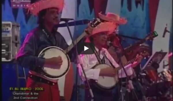 He wasn't large in stature, but he would stand there in the centre of his musical group known as the "La Ceylonians", over-large straw hat on his head, simple open-necked shirt, with the inevitable sarong, generally worn by most Sri Lankans and barefoot, clutching either an acoustic guitar or a banjo-mandolin and singing songs, many of which he wrote himself. Noel Ranasinghe was his name, and he came into prominence in the early 60s. I did read a couple of stories about the La Ceylonians and was quite amazed to read that Noel and his group entertained audiences in many parts of the World. He actually promoted this Calypso type Baila more than several other bands did, in Ceylon at the time. I happened to see Tharuna Jeewithe' Ape' Vinodayen on you-tube, quite by chance and decided to publish this great song on e'Lanka, dedicating it, in fact, to Noel who passed on aged 73, after a fairly long illness in 2015. Rest in peace, Noel. I was not privileged to meet you in person, having left for Australia in 1961. Your music, together with the La Ceylonians will always be popular with thousands of your fans, so rest easy, my friend. If you are a Sri Lankan, this song should bring back many memories. The presentation as a whole, is superb. Desmond Kelly. (Editor-in-Chief) e'Lanka.