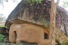 Hatthikucchi Viharaya - ruined ancient temple complex framed by rock boulders By Arundathie Abeysinghe