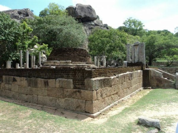 Hatthikucchi Viharaya - ruined ancient temple complex framed by rock boulders By Arundathie Abeysinghe