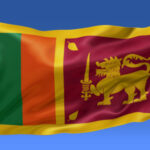Sri Lanka flag waving on the flagpole on a sky background